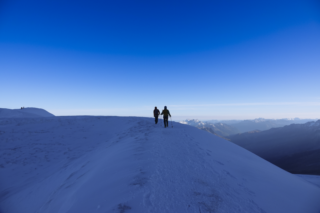 Two Life Happens Outdoors climbers crossing the glacial plain between the Dôme du Goûter and the summit of Mont Blanc