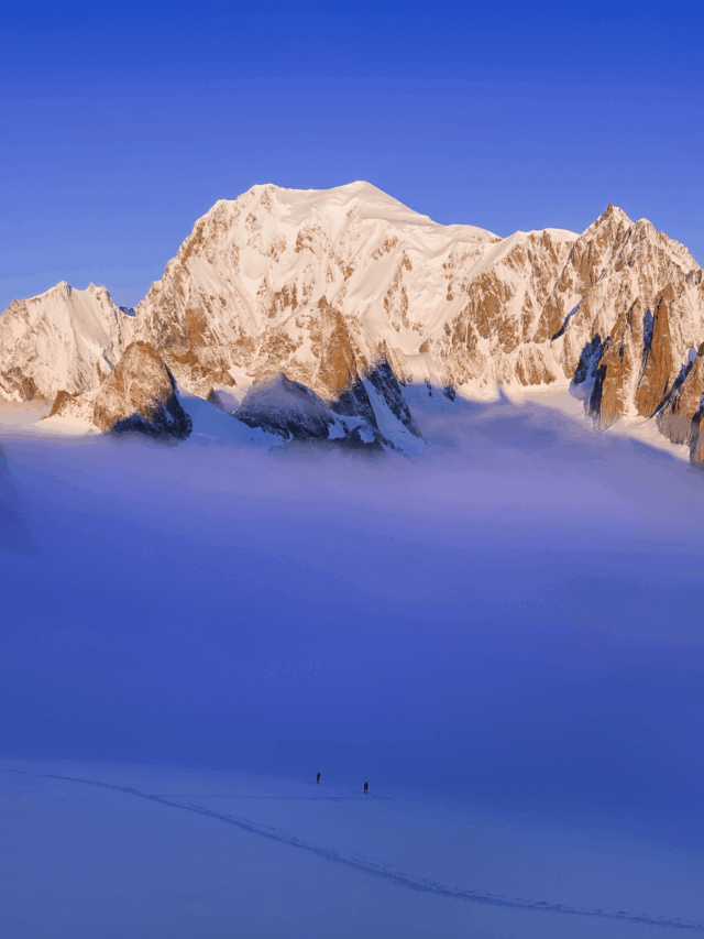 Two Life Happens Outdoors climbers ascending the Vallée Blanche at sunrise with Mont Blanc towering behind them.