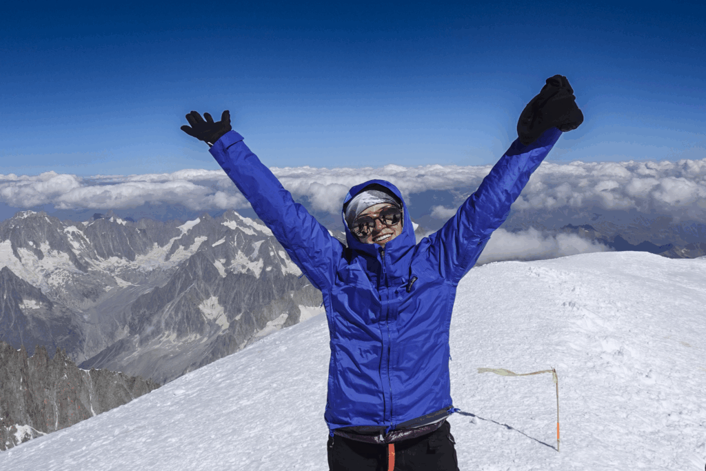 Life Happens Outdoors climber on the summit of Mont Blanc at 4,810 m, taking in the views after the summit push.