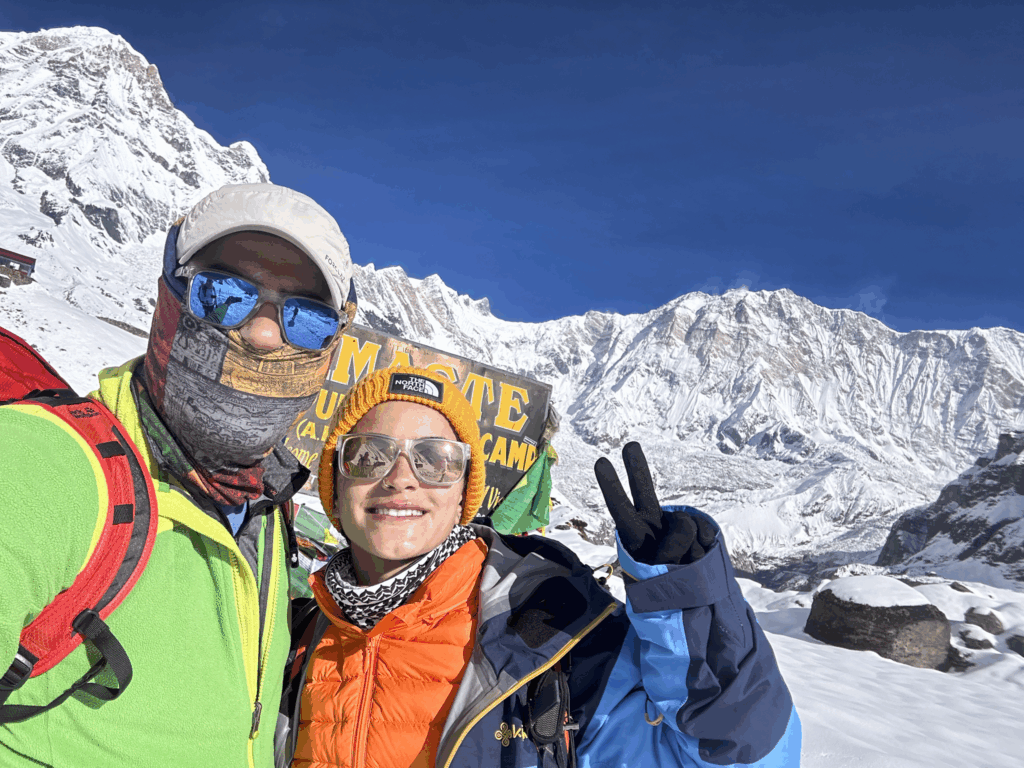 Life Happens Outdoors community members at Annapurna Base Camp with fresh snow and clear blue sky in the Nepal Himalaya