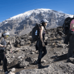 Life Happens Outdoors community members trekking from Karanga Camp to Barafu Camp on the Machame Route with Mount Kilimanjaro in the background.