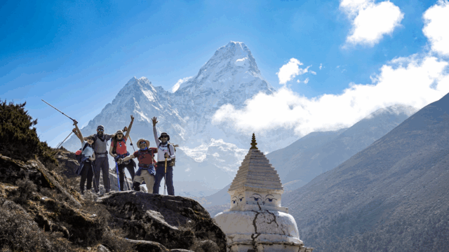 Life Happens Outdoors community members celebrating at the base of Ama Dablam during the Everest Base Camp trek.