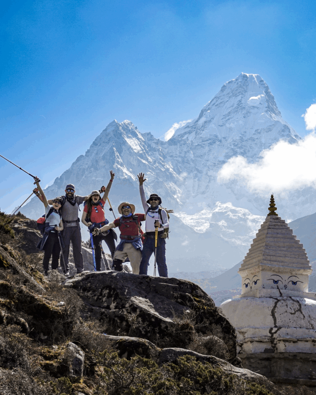Life Happens Outdoors community members celebrating at the base of Ama Dablam during the Everest Base Camp trek.