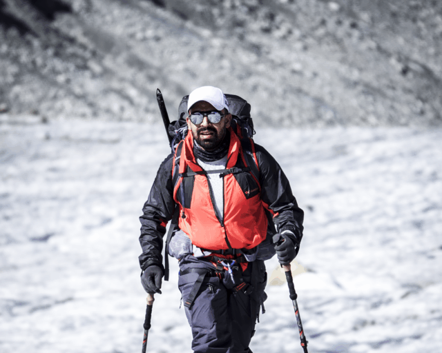Life Happens Outdoors team member on his first day glacier hiking, stepping onto a glacier in the Alps.