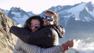 Two Life Happens Outdoors community members embracing at Cabane de Bertol on the Chamonix to Zermatt Haute Route expedition.