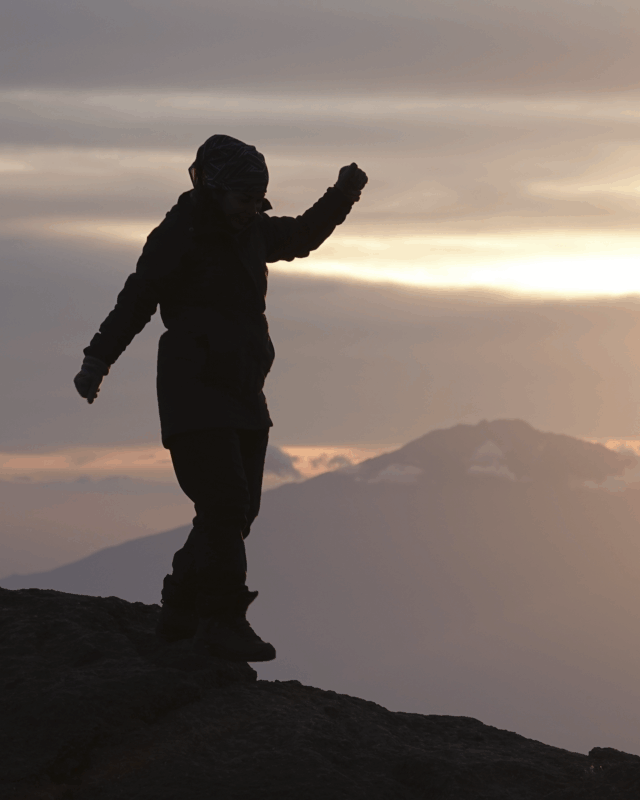 Life Happens Outdoors community member enjoying a quiet sunset alone from Karanga Camp on the Kilimanjaro climb.