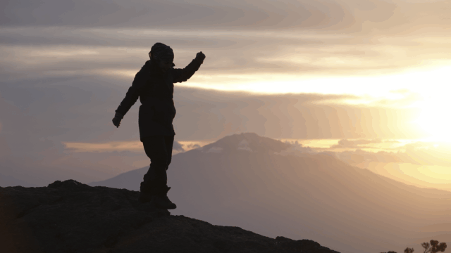 Life Happens Outdoors community member enjoying a quiet sunset alone from Karanga Camp on the Kilimanjaro climb.