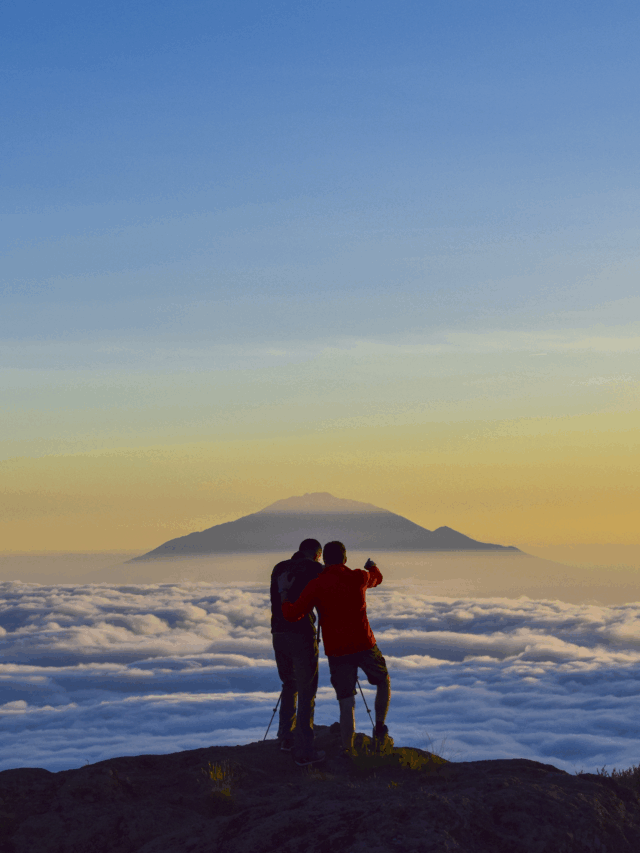 Two Life Happens Outdoors climbers watching a sea of clouds at sunset from Shira Camp on the Machame Route on Kilimanjaro.