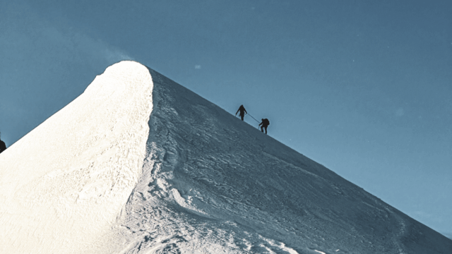 Life Happens Outdoors team roped together climbing Mont Blanc on summit day in the Alps.