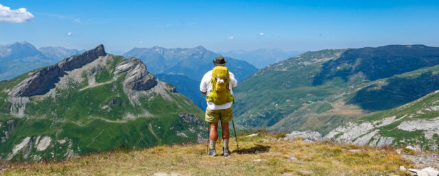 Tour du Mont Blanc trekker from Life Happens Outdoors looking out over the Alps toward the horizon during a guided hiking adventure