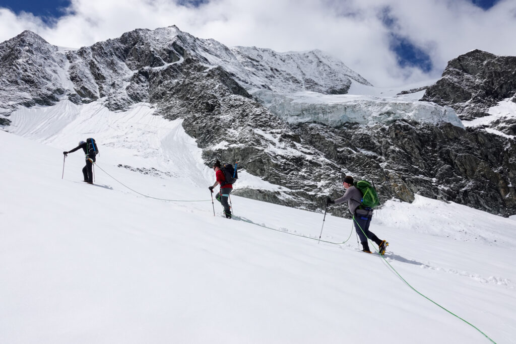 Life Happens Outdoors team roped up on a glacier during the Chamonix to Zermatt Haute Route ascent.
