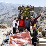 Life Happens Outdoors community members celebrating arrival at Barafu Camp, the summit base camp on Kilimanjaro.