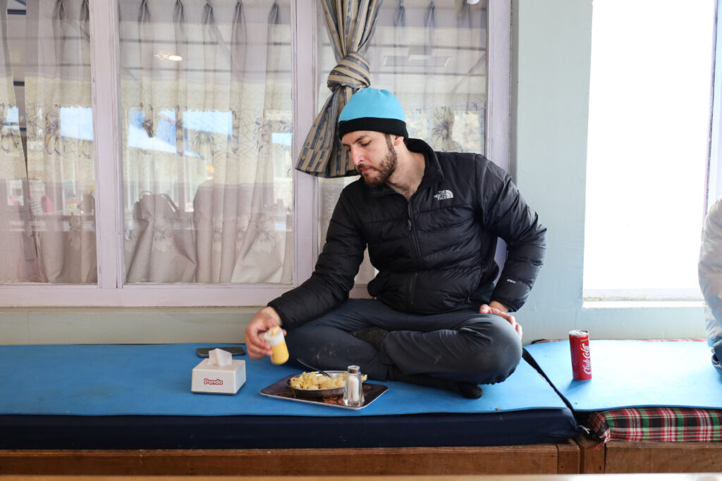 Life Happens Outdoors trekker enjoying a quiet meal at a teahouse on the Annapurna Base Camp trek